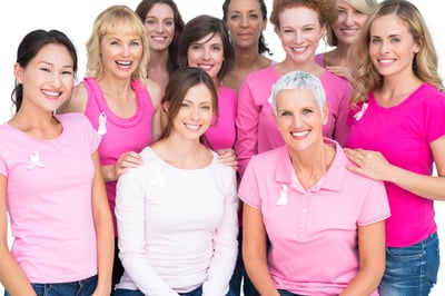 Voluntary pretty women posing and wearing pink for breast cancer on white background