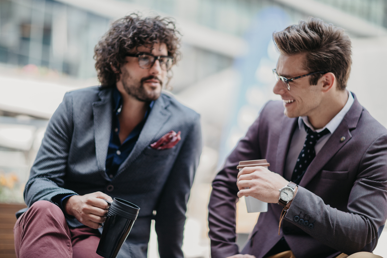 Two professional men chatting over coffee